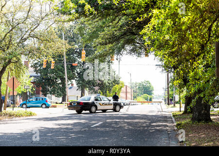Montgomery, USA - April 21, 2018: Alabama city police officer car on street, with sign, people walking on sidewalk, blocked road, roadblock, block Stock Photo