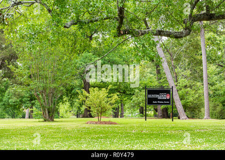 Montgomery, USA - April 21, 2018: Sign for private liberal arts Huntingdon College in Alabama with green park entrance Stock Photo