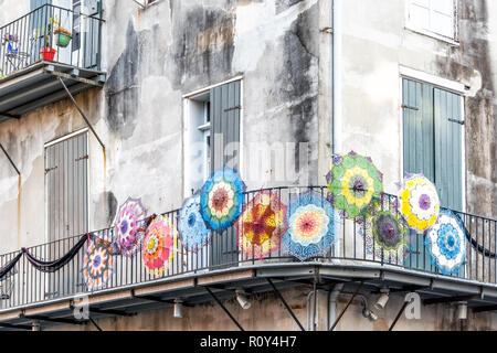 New Orleans, USA - April 22, 2018: Antique store with umbrellas colorful design on balcony street in Louisiana famous town, city, nobody Stock Photo