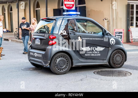 New Orleans, USA - April 22, 2018: Downtown old town in Louisiana famous city during day with security police guard officer smart car on Decatur stree Stock Photo