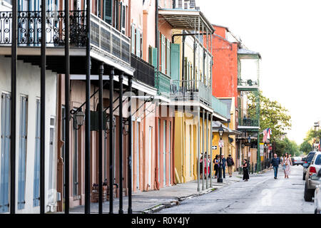 New Orleans, USA - April 22, 2018: Old town street in Louisiana famous city, cast iron balconies pattern wall buildings, multicolored colorful archite Stock Photo