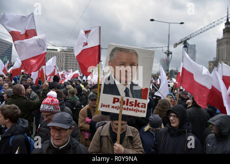 November 11, 2017 - Warsaw, mazowieckie, Poland - A Nationalists seen holding the portrait of Jaroslaw Kaczynski (leader of PiS party) and waving flags on the Independence Day during the demonstration.Last year about 60,000 people took part in the nationalist march marking Poland's Independence Day, according to police figures. The march has taken place each year on November 11th for almost a decade, and has grown to draw tens of thousands of participants, including extremists from across the EU.Warsaw's mayor Hanna Gronkiewicz-Waltz has banned the event. Organizers said they would appea Stock Photo