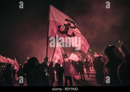 November 11, 2017 - Warsaw, mazowieckie, Poland - A protester seen holding a flag during the demonstration.Last year about 60,000 people took part in the nationalist march marking Poland's Independence Day, according to police figures. The march has taken place each year on November 11th for almost a decade, and has grown to draw tens of thousands of participants, including extremists from across the EU.Warsaw's mayor Hanna Gronkiewicz-Waltz has banned the event. Organizers said they would appeal against the decision, insisting they would go ahead with the march anyway and raising the pr Stock Photo