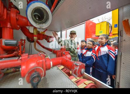 Handan, China's Hebei Province. 8th Nov, 2018. A fire fighter introduces a fire engine to a group of students in Handan, north China's Hebei Province, Nov. 8, 2018. Fire safety awareness campaigns have been held across China in the run-up to the National Fire Prevention Day on Nov. 9. Credit: Zhu Xudong/Xinhua/Alamy Live News Stock Photo