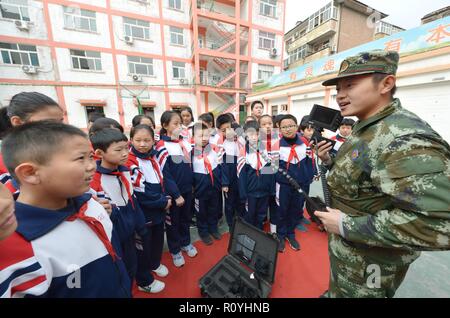 Handan, China's Hebei Province. 8th Nov, 2018. A fire fighter introduces a detective device to a group of students in Handan, north China's Hebei Province, Nov. 8, 2018. Fire safety awareness campaigns have been held across China in the run-up to the National Fire Prevention Day on Nov. 9. Credit: Zhu Xudong/Xinhua/Alamy Live News Stock Photo