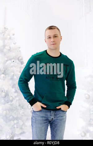 Handsome man posing in studio with white background. Stock Photo