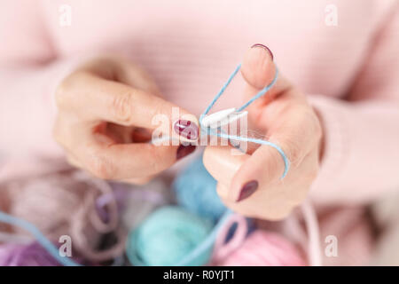 Knitting baby things, close up colored clew in hand Stock Photo