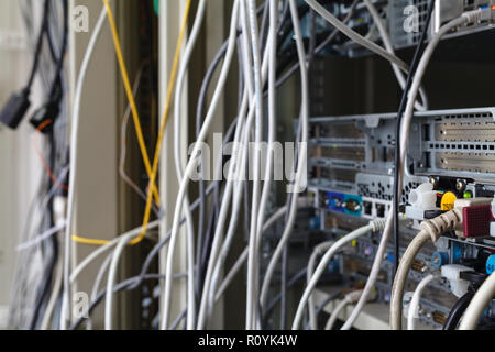 Patch Panel server rack with gray cords in the background Stock Photo