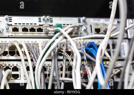 Patch Panel server rack with gray cords in the background Stock Photo
