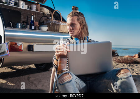 Couple of freelancers living in mobile home working using their laptops Stock Photo