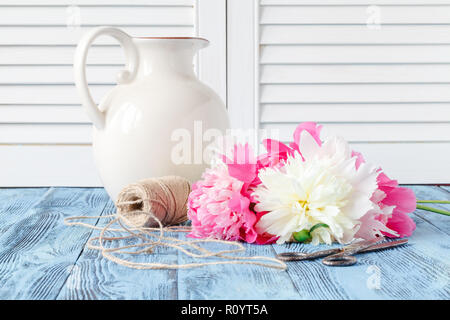 Tools and accessories florists need for making up a bouquet out of peonies Stock Photo