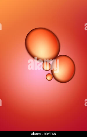 Backlit transparent beauty orange colour oil with bubbles, studio shot Stock Photo