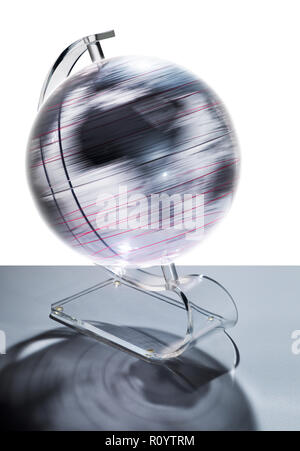 Transparent globe rotating at speed, studio shot Stock Photo