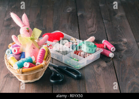 bright threads in basket, scissors and measuring tape Stock Photo
