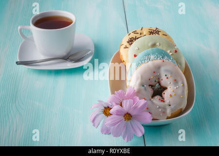 Four donuts on old wood table Stock Photo
