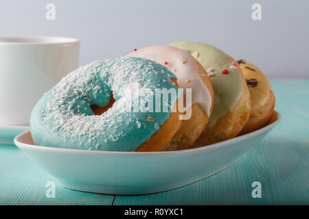 Four donuts on old wood table Stock Photo
