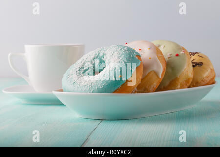 Four donuts on old wood table Stock Photo