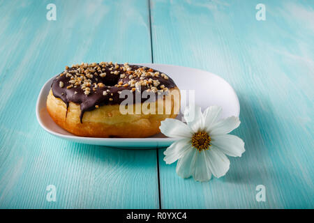 donuts on old wood table with flower Stock Photo