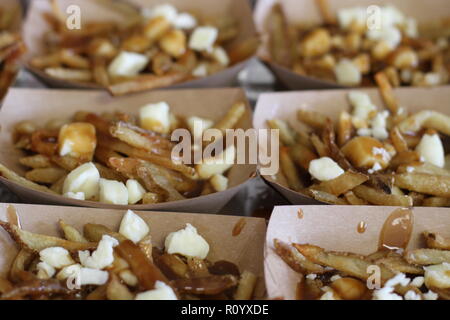 French fries with cheese curds in small boxes Stock Photo