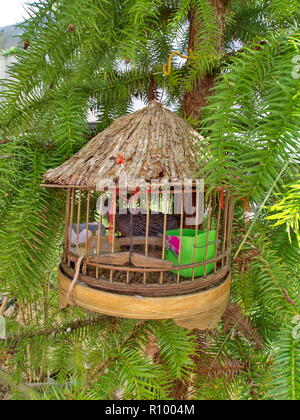 Birg Cage on the tree in the local village in Da Lat City. Travel in Vietnam in 2012, 5th December Stock Photo