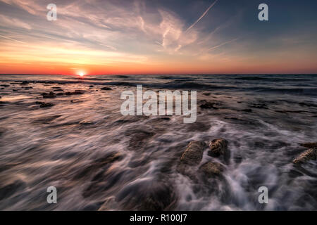 Beautiful sunrise over the sea with water motion blur Stock Photo