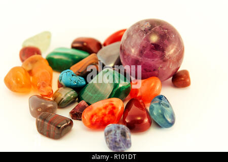 Semi precious stones / Crystal Stone Types / healing stones, worry stones, palm stones, ponder stones / Various stones gemstones background texture. Stock Photo