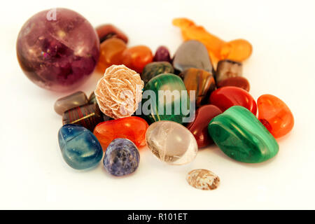 Semi precious stones / Crystal Stone Types / healing stones, worry stones, palm stones, ponder stones / Various stones gemstones background texture. Stock Photo