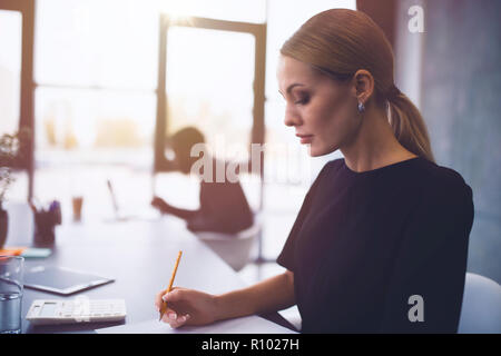 Businesswoman at the office working with a laptop with his team Stock Photo