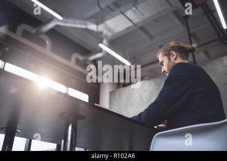 Businessman at the office working with a laptop with his team Stock Photo