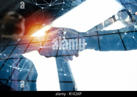 Handshaking business person in the office with network effect. concept of teamwork and partnership. double exposure Stock Photo