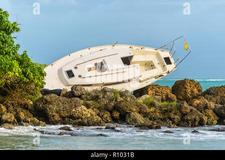 Sailboat was destroyed and abandoned on the shore after a hurricane - the Gosier in Guadeloupe, Caribbean Stock Photo