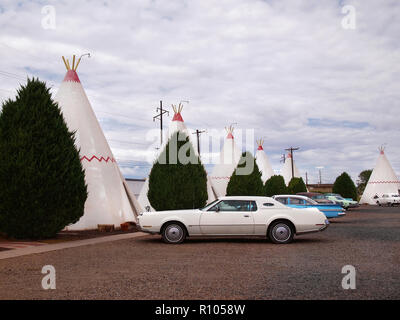HOLBROOK, AZ - JULY 12, 2018: A collection of vintage American cars parked in front of teepee shaped guest rooms at the Wigwam Motel in Holbrook, Ariz Stock Photo