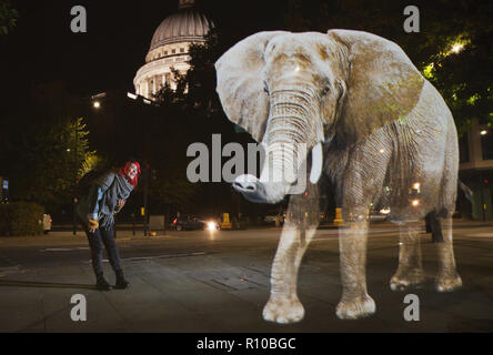 WWF Hologram - Elephant crosses the road in London  It's time to address the elephant in the road. WWF uses hologram and imaginative animal crossings to show Londoners how they can prevent illegal wildlife trafficking.  Featuring: Atmosphere Where: London, United Kingdom When: 08 Oct 2018 Credit: Joe Pepler/PinPep/WENN.com Stock Photo