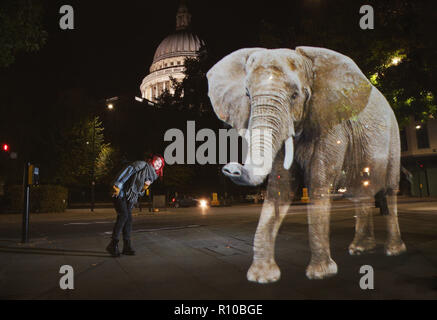 WWF Hologram - Elephant crosses the road in London  It's time to address the elephant in the road. WWF uses hologram and imaginative animal crossings to show Londoners how they can prevent illegal wildlife trafficking.  Featuring: Atmosphere Where: London, United Kingdom When: 08 Oct 2018 Credit: Joe Pepler/PinPep/WENN.com Stock Photo