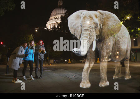 WWF Hologram - Elephant crosses the road in London  It's time to address the elephant in the road. WWF uses hologram and imaginative animal crossings to show Londoners how they can prevent illegal wildlife trafficking.  Featuring: Atmosphere Where: London, United Kingdom When: 08 Oct 2018 Credit: Joe Pepler/PinPep/WENN.com Stock Photo