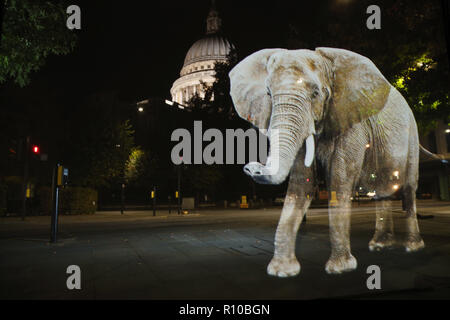 WWF Hologram - Elephant crosses the road in London  It's time to address the elephant in the road. WWF uses hologram and imaginative animal crossings to show Londoners how they can prevent illegal wildlife trafficking.  Featuring: Atmosphere Where: London, United Kingdom When: 08 Oct 2018 Credit: Joe Pepler/PinPep/WENN.com Stock Photo