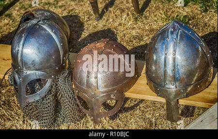 Three helmets with nose protection as worn by medieval knights in the Middle Ages. Stock Photo
