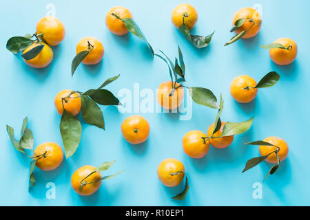 Fresh mandarin isolated on blue punchy pastel. Top view. Fruits pattern. Stock Photo