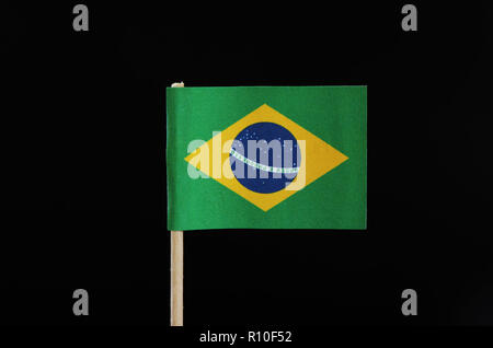 A national flag of Brazil on toothpick on black background. A green field with the large yellow diamond. In the middle of circle there is blue field i Stock Photo