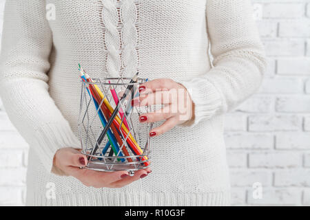 color pencils inside box in hand Stock Photo