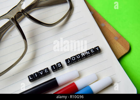 Live is journey message written on wooden blocks. education and motivation concepts. Cross processed image on green Background Stock Photo