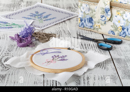 Set for embroidery, embroidery hoop, linen fabric, thread, scissors, embroidered needle bed Stock Photo