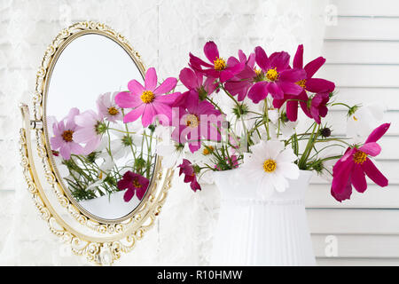 interior with mirror and a table with a vase and flovers Stock Photo