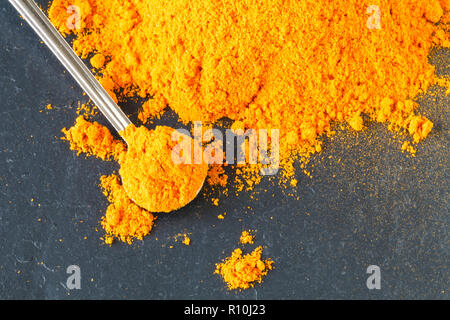 Heap of Turmeric (selective focus) on an old wooden table Stock Photo