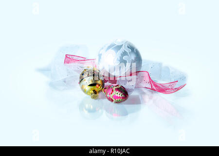 Three pretty Christmas decorations and ribbons, white background Stock Photo