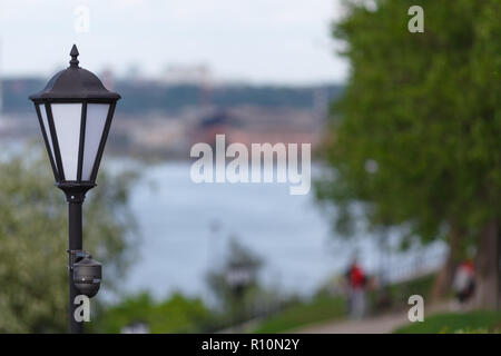CCTV surveillance camera mounted on vintage street lantern Stock Photo