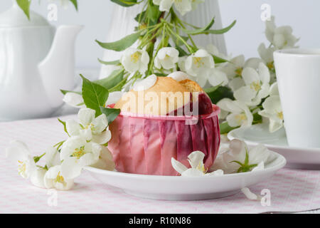 Cake on the background of the cherry blossoms Stock Photo