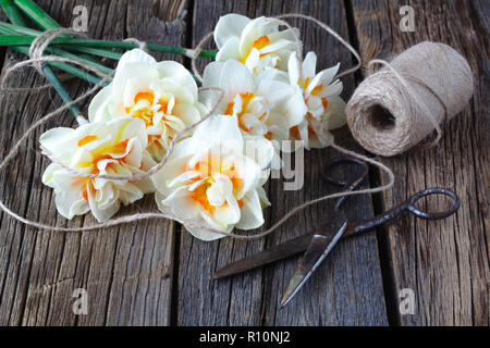 white daffodil flowers on old wood table background Stock Photo