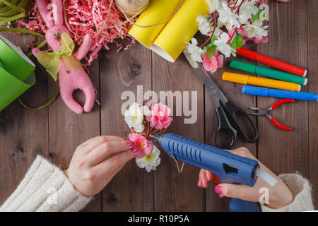 Woman make floral decor with melt glue gun Stock Photo - Alamy