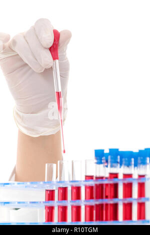 Scientist filling test tubes with pipette in laboratory Stock Photo